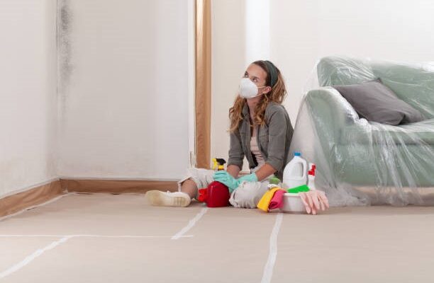 A woman cleaning mold with wearing the mask